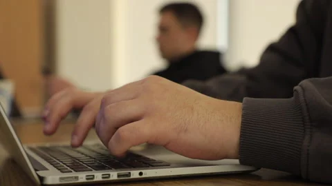 A man typing on a laptop keyboard in the office Stock Footage 234771791