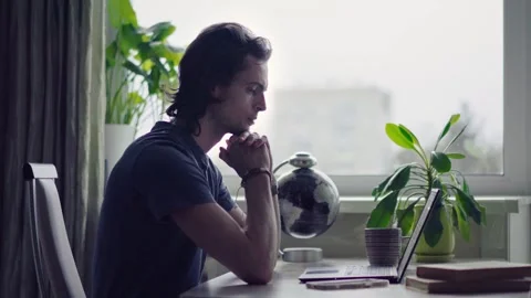 Man typing on laptop keyboard working at home in front of a window Video stock 272197590