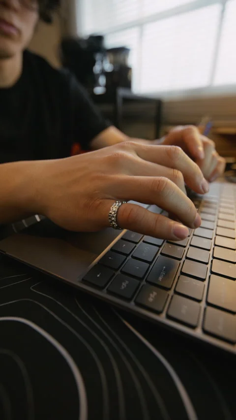 Man Typing on Laptop Keyboard Working Remotely at Home Office Stock Footage 338421837