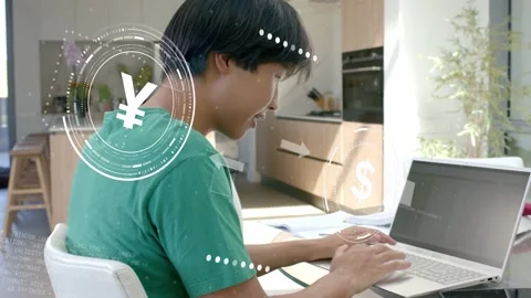 Man typing on laptop in kitchen, activating finance HUD and currency symbols Stock Footage 333510362