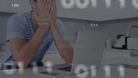 Man typing laptop kitchen, showing binary data around laptop, pausing then Stock Footage 328469398