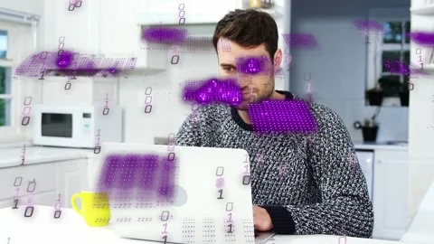 Man typing on laptop in kitchen working in tech, causing purple blocks obscuring Stock Footage 333790232