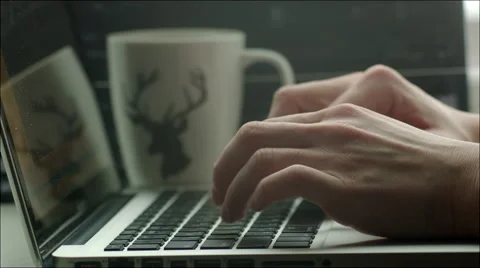 Man Typing in Laptop, Mug Standing Nearby Stock Footage 60383652