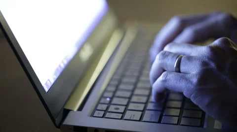 Man typing on a laptop at night time in dark space. Video stock 51709378