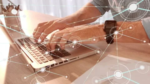 Man typing at laptop, node appearing, animated network expanding across desk Stock Footage 330237392