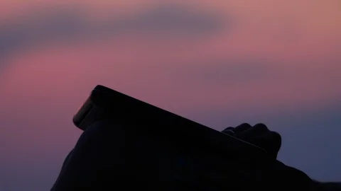 Man typing on laptop, notebook on sunset background. Close-up of gadget and man Stock-Footage 113762854