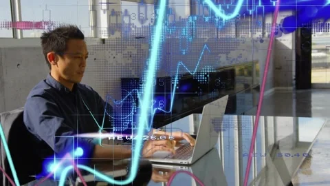 Man typing on laptop in office causing finance charts shifting and world-map Stock Footage 318544358