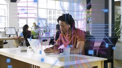 Man typing on laptop in office, causing holographic code and magenta grids Stock Footage 333369214
