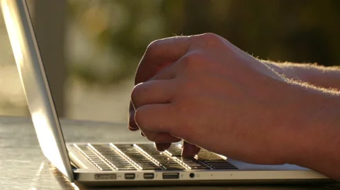 Man typing on a laptop outside Video stock 51770405