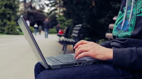 Man Typing On Laptop In The Park Stock Footage