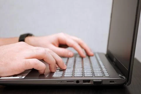 Man is typing on a laptop Stock Photos