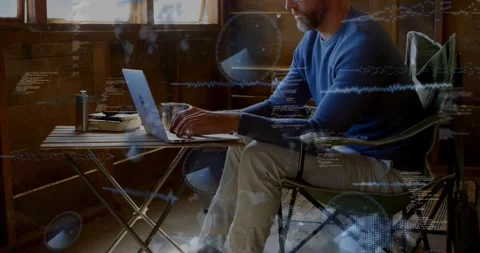 Man typing on laptop starting animated code and waves appearing around him Stock Footage 328229504