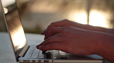 Man typing on a laptop at sunset Stock Footage 50184508