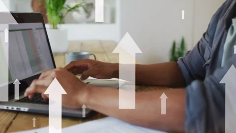 Man typing on laptop at table, generating animated arrows over screen and Stock Footage 335317295