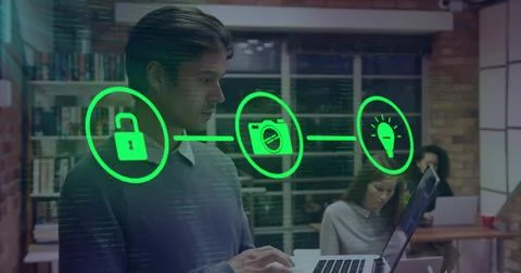 Man typing on laptop in tech hub, causing green lock camera bulb icons linking Stock Photos