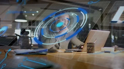 Man typing on laptop in tech office initiating AR HUD hovering over torso and Stock Footage 334788500
