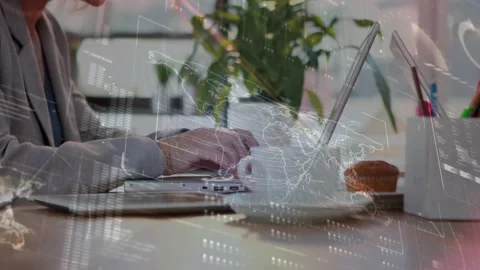 Man typing on laptop in technology office, initiating pulsing map overlay while Stock Footage 311901931