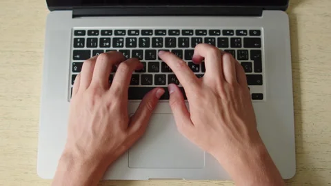Man typing on a laptop. Top down close up shot of a person actively typing .. Stock Footage 339859217