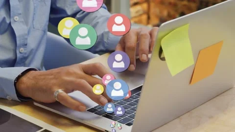 Man typing on laptop user icons appearing and expanding around hands signaling Stock Footage 334351894