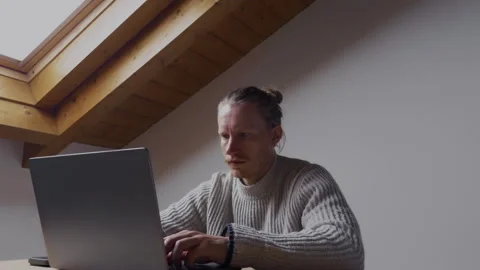 Man typing on laptop while working remotely from home office Stock-Footage 334736042