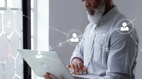 Man typing on laptop by window, starting tech nodes on laptop screen and Stock Footage 331048123