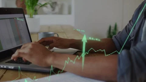 Man typing on laptop at wood table entering data and analyzing finance causing Stock Footage 335235512