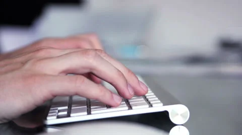 Man is typing in a Mac Apple keyboard. Stock Footage 39992759