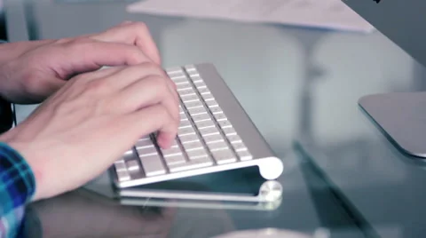 Man typing in a Mac Apple keyboard. Stock Footage 39994650