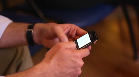 Man typing message on a moble phone during business meeting conference Stock Footage 46033985