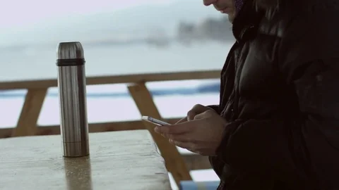 Man typing a message on a phone at winter outdoor Stock Footage 70803306