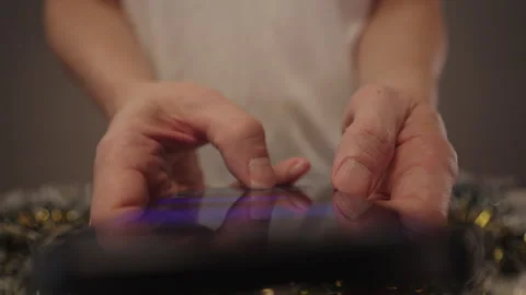 Man typing message on smartphone celebrating Christmas, sending holiday Stock Footage 323449994