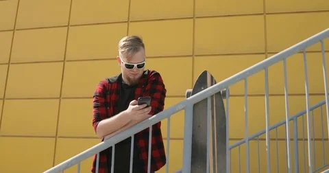 Man Typing a Message Using Mobile Phone Stock Footage 74978300