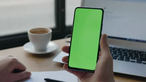 Man typing at the mobile phone vertical green screen. Chroma key and mock up. Stock Footage 170431764