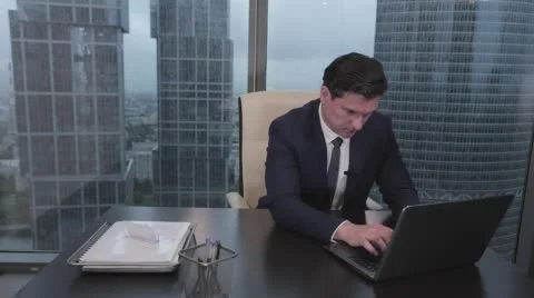 Man typing on notebook and then pretty smiling Stock Footage 64073520