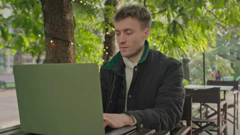 Man typing on notebook in the cafe writing notes. Freelancer works with notebook Stock Footage 150727028