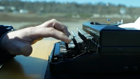 Man typing on an old typewriter with his hands in the open air Stock Footage 104898442