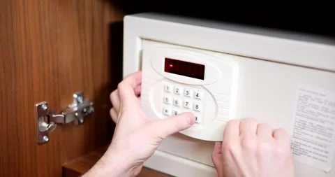 Man typing password on combination lock of safe to open it closeup 4k movie slow Stock Footage 257889153