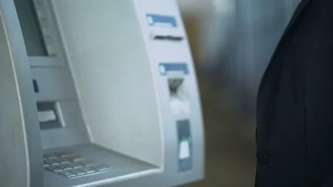 Man typing pin code on ATM keyboard to withdraw dollars from bank account Stock Footage 90915538
