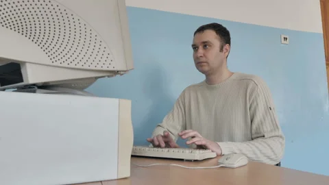 Man typing on retro keyboard, but something is not working.  Stock Footage 126085729
