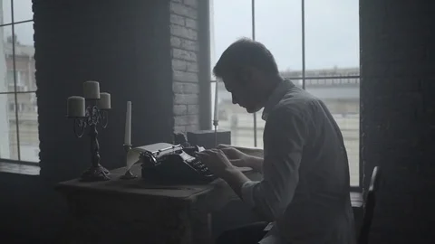 Man typing on retro typewriter in the loft Stock Footage 72634446