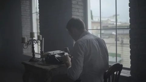 Man typing on retro typewriter in the studio Stock Footage 72634353