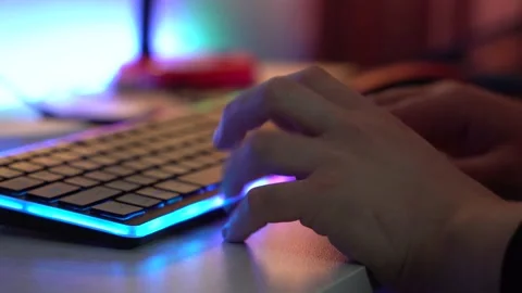 Мan is typing on a RGB keyboard Stock Footage 189514656