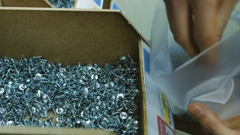 The man is typing screws in the package | Stock Video | Pond5