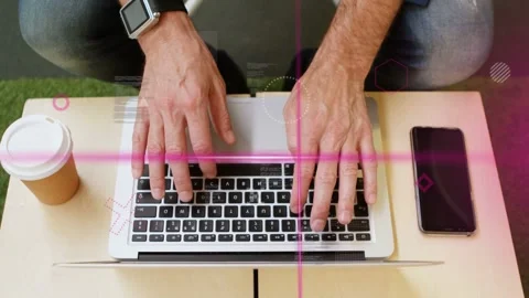 Man typing on silver laptop and starting pink overlays sliding over keyboard, 库存影片 334465955