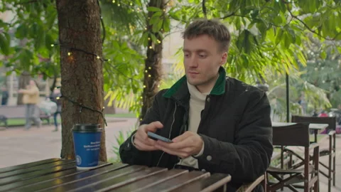 Man typing on smartphone in the cafe writing notes freelancer works with phone Stock Footage 150727496