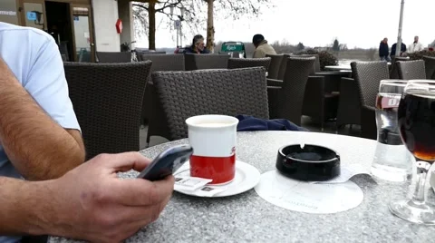 Man Typing on A Smartphone While Drinking Coffee Stock Footage 47340504