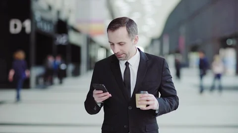 Man typing sms and having coffee in business center Stock Footage 108681667