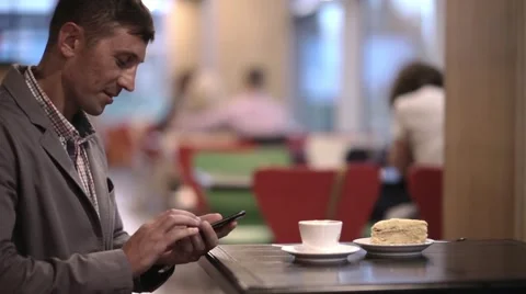 A man is typing sms in cafe Stock Footage 57850139