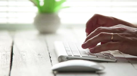 A man typing something fast on the wireless keyboard Stockbeeldmateriaal 61787239