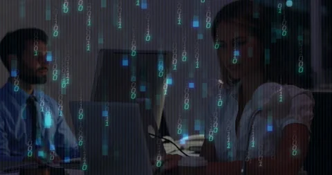 Man typing sparking binary overlay cascade as colleague entering code for tech Stock Footage 310330823